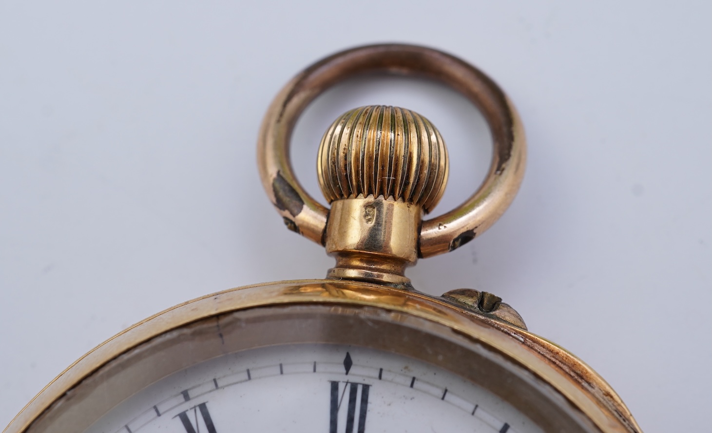 A continental 18k gold open faced keyless lever pocket watch, with a 9ct albert